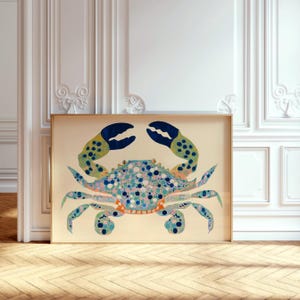 May include: A colorful illustration of a blue crab with yellow and green accents on a cream background. The crab is depicted in a detailed, stylized manner with a variety of blue, green, yellow, and pink dots and circles.