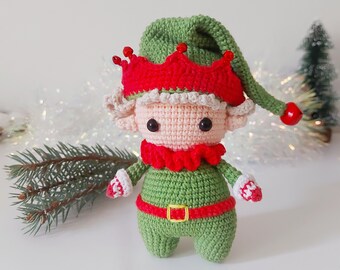 May include: A crocheted elf doll with a green hat, red and white hat trim, and a red and green outfit. The elf has a pink face with black eyes and a white crocheted beard.