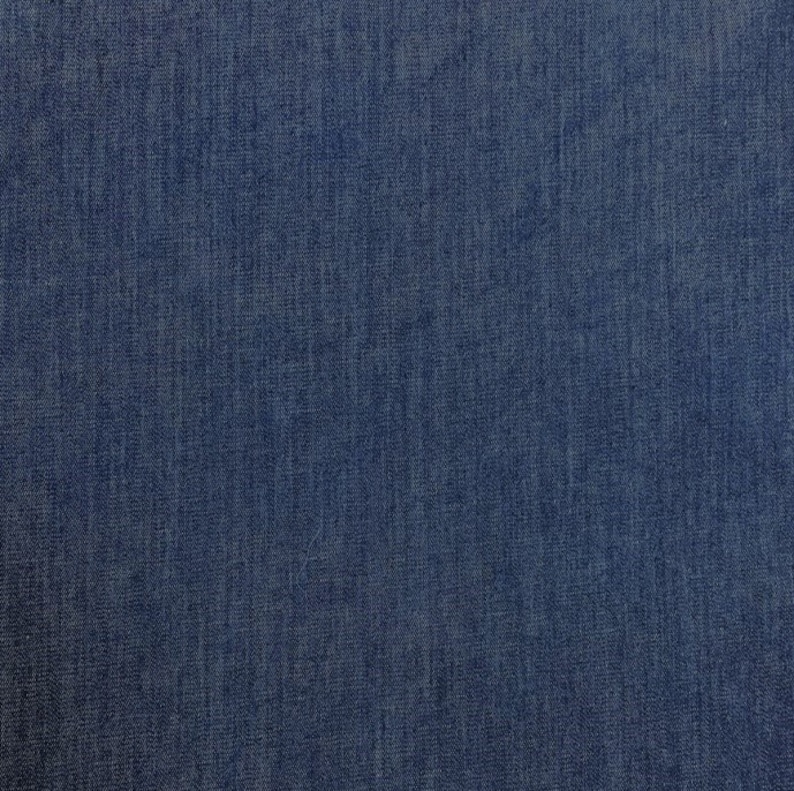 May include: A close-up of a dark blue denim fabric with a woven texture.