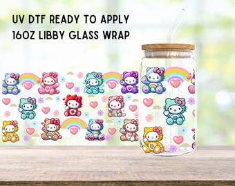 May include: A 16 oz glass tumbler with a straw, wrapped with a colorful design featuring Hello Kitty characters and rainbows. The design includes pink, blue, yellow, and white colors. The text "UV DTF Ready to Apply" is at the top of the image.