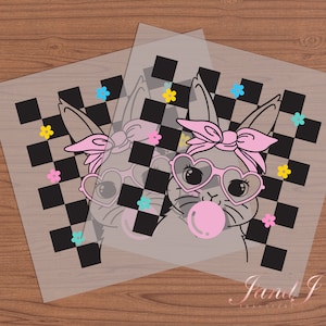 May include: A pink bunny rabbit with a pink bandana and heart-shaped sunglasses is blowing a bubble on a black and white checkered background with pink, blue, and yellow flowers.
