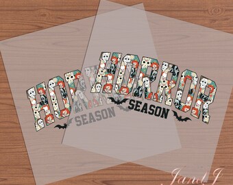 May include: A clear sheet of transfer paper with the words "Horror Season" printed in black letters. The letters are filled with a pattern of horror movie character faces, including Freddy Krueger, Jason Voorhees, and Michael Myers.