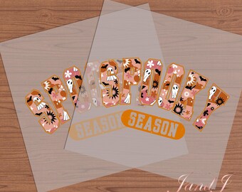 May include: A pink and orange graphic design with the text "Spooky Season" in a retro font. The design features ghosts and flowers.