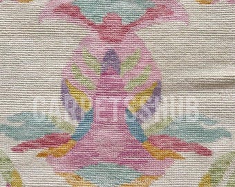 May include: A woven textile featuring a repeating symmetrical floral pattern in shades of pink, light blue, yellow, and green on an off-white background. The design includes stylized petal and leaf motifs with a visible horizontal weave texture.
