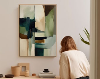 May include: Abstract art print with green, blue, and brown geometric shapes in a wooden frame hanging on a white wall above a wooden desk with books and decorative objects.