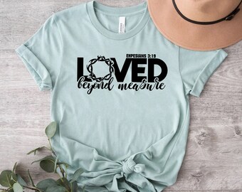 Könnte beinhalten: Ein hellblaues T-Shirt mit schwarzem Text, der "Loved beyond measure" und "Ephesians 3:19" lautet.
