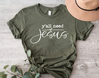 May include: A green t-shirt with the text "y'all need Jesus" in white lettering.