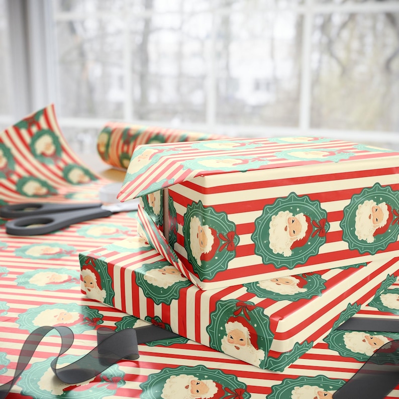 May include: Christmas-themed gift boxes wrapped in red and cream striped paper with Santa Claus medallions. A roll of matching wrapping paper and scissors are visible, along with a black ribbon. The scene is set on a table near a window.