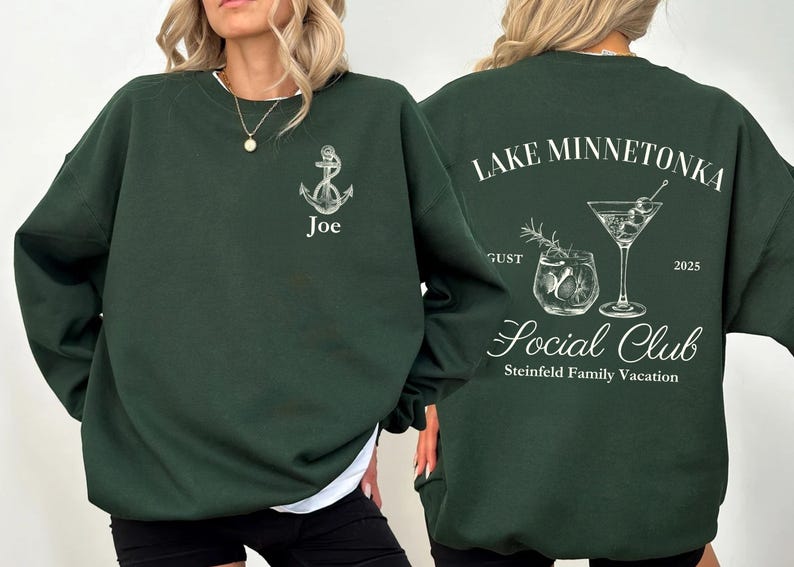 May include: Dark green sweatshirt with white graphic designs. The front features an anchor and the name "Joe". The back displays "Lake Minnetonka Social Club" with cocktail illustrations, "August 2025", and "Steinfield Family Vacation".