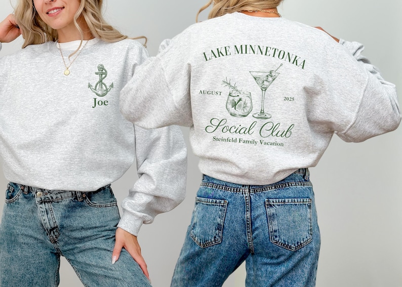 May include: Light gray sweatshirt with a green anchor and the name "Joe" on the front. The back features the text "Lake Minnetonka Social Club" with a cocktail graphic, the date "2025", and the text "Steinfeld Family Vacation."