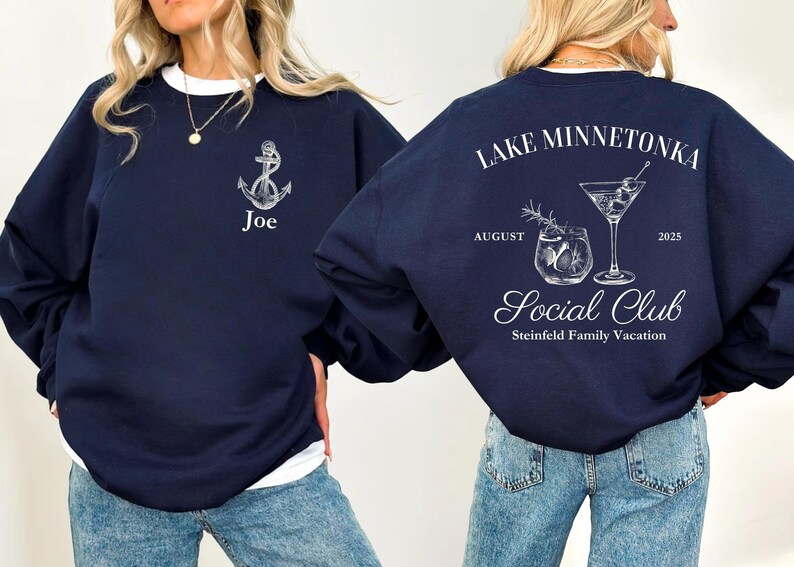 May include: Navy blue sweatshirt with white accents. The front features an anchor graphic and the name "Joe". The back displays "Lake Minnetonka Social Club" with cocktail illustrations, the month of August, and the year 2025. A family vacation theme.