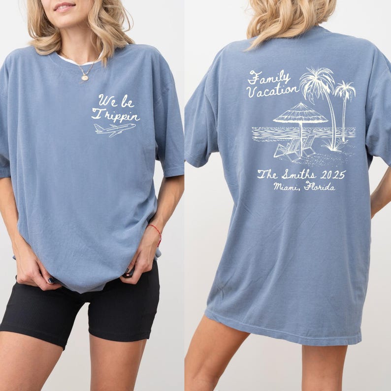 May include: A light blue t-shirt with a white graphic on the front that says "We be Trippin'" with a small airplane. The back of the shirt has a white graphic of a beach scene with palm trees, an umbrella, and two lounge chairs. The text "Family Vacation" is above the scene and "The Smiths 2025 Miami, Florida" is below the scene.