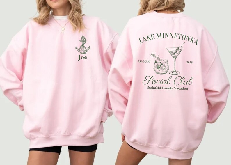 May include: Pink sweatshirt with an anchor graphic and the name "Joe" on the front. The back features text that reads "Lake Minnetonka Social Club August 2025" with cocktail illustrations. A casual, comfortable garment.