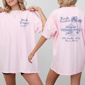 May include: Pink t-shirt with the text "We be Trippin" and a small airplane graphic on the front. The back of the shirt has the text "Family Vacation" with a palm tree and beach scene and the text "The Smiths 2025 Miami, Florida".