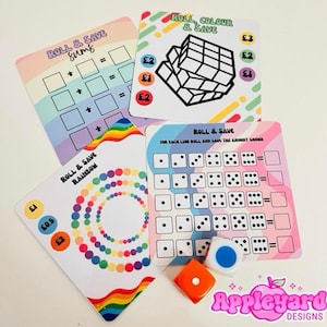 May include: Four square game cards with colourful rainbow designs and text including Roll & Save Sums, Roll, Colour & Save, Roll & Save Rainbow, and Roll & Save. Two six-sided dice, one orange and one white with a blue dot, are included in the set.