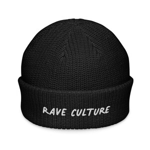 May include: A black beanie with a folded brim. The text "RAVE CULTURE" is embroidered in white across the front. The hat is made of a ribbed knit material.
