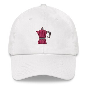 May include: White baseball cap with an embroidered pink coffee pot design.