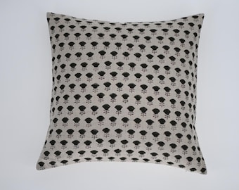 May include: Square decorative pillow with a neutral background and a repeating pattern of black floral designs. The pillow is a square shape, perfect for a sofa or bed. The pillow's dimensions are approximately 18 inches by 18 inches.