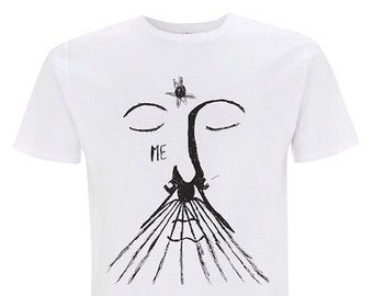 May include: White t-shirt with a black and white illustration of a face with closed eyes and a long nose. The text "ME" is printed below the eyes.