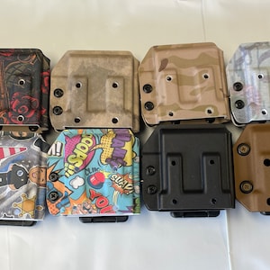 May include: Twelve different patterned magazine pouches for concealed carry. The pouches are made of a durable material and have a variety of colors and designs.