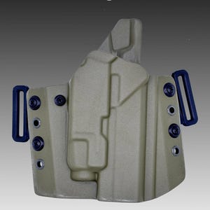 May include: A green polymer holster for a Staccato C/C2 pistol with a Streamlight TLR7 light attachment. The holster has a belt loop and multiple mounting points. OD GREEN.