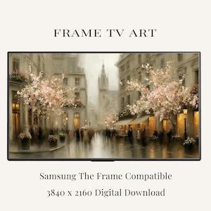 May include: A digital artwork for a television screen titled FRAME TV ART, featuring a European street scene with blooming pink cherry blossom trees, historic buildings, and street lamps. It is Samsung The Frame compatible, 3840 x 2160 pixels.