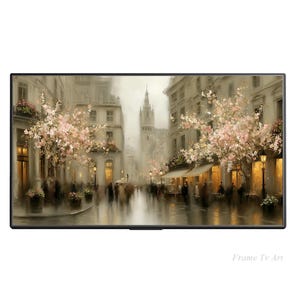 May include: A digital painting of a European street scene, displayed on a black framed TV. The artwork depicts a rainy day with people walking along a cobblestone street, lined with buildings and blooming trees. The artwork is signed "Frame Tv Art".