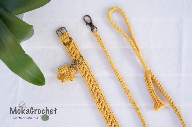 May include: A yellow crocheted dog collar and leash set with a flower charm. The collar has a metal buckle and the leash has a tassel.  MokaCrochet - Handmade with Love.