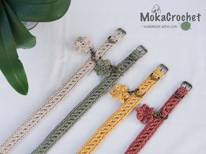 May include: Four crocheted dog collars with flower charms in beige, green, yellow, and red. The collars are handmade and feature adjustable buckles.  "MokaCrochet - Handmade with Love" is written on a white background.