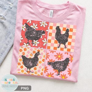 May include: A light pink t-shirt featuring a four-panel graphic print. Each panel displays a black speckled chicken silhouette against different backgrounds: white daisies on red, an orange and white checkerboard, orange flowers on cream, and pink flowers.