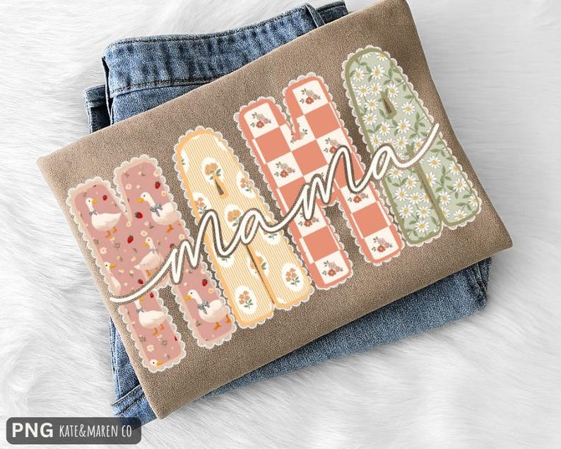 May include: A tan t-shirt featuring the word MAMA in large, scalloped-edge letters. Each letter has a unique pattern: ducks on pink, yellow stripes with flowers, a peach and white checkerboard, and white daisies on a sage green background.