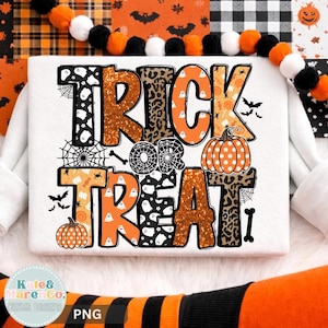 May include: A white rectangular graphic featuring the text TRICK OR TREAT in large, stylized letters. The letters incorporate patterns of ghosts, leopard print, orange glitter, and pumpkins. Decorative elements include spider webs, bats, and bones.