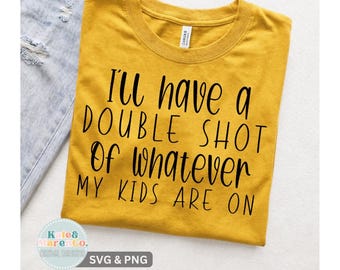 May include: A mustard yellow short-sleeved t-shirt with black text printed on the front that reads, I'll have a double shot of whatever my kids are on. The shirt features a crew neckline and a standard fit, displayed flat against a neutral background.