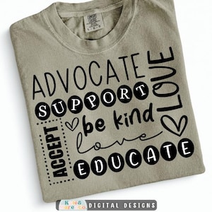 May include: A light olive green t-shirt featuring black text that reads ADVOCATE, SUPPORT, be kind, love, ACCEPT, and EDUCATE. The design includes black circular accents around the words SUPPORT and EDUCATE, along with two heart icons.