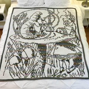 May include: A rectangular crochet blanket featuring a white background with a dark gray outline design of a caterpillar sitting on a large mushroom, smoking a hookah, with a person standing nearby, all rendered in a multi-colored yarn pattern.