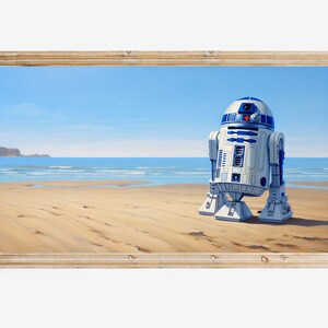 May include: A framed painting of a blue and white robot standing on a sandy beach with a blue ocean and a cloudy sky in the background.