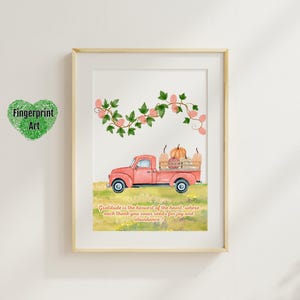 May include: A printable art print featuring a red truck with a bed full of pumpkins and gourds. The truck is driving through a field of green grass and pink flowers. The quote "Gratitude is the harvest of the heart, where each thank you sows seeds for joy and abundance" is printed below the truck.