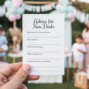 Puede incluir: Una tarjeta blanca con el texto "Advice for New Dads" en escritura elegante. La tarjeta incluye indicaciones para consejos, como "Best advice for the early days" y "Don't forget to". El fondo es una escena borrosa al aire libre.
