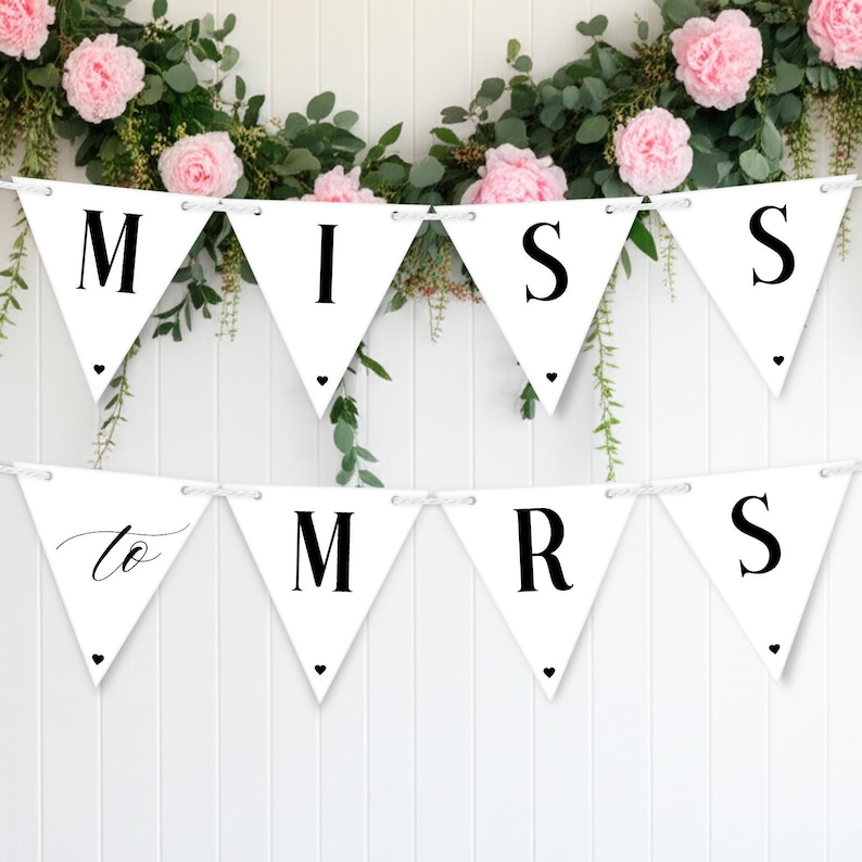 Puede incluir: Guirnalda de banderines blancos con letras negras que deletrean "MISS" y "MRS", con "to" en cursiva. Decorada con peque&ntilde;os corazones negros, se coloca contra una pared blanca con acentos florales y verdes.