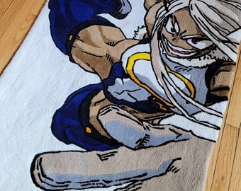 May include: A white rug with a cartoon image of a woman with white hair and a blue and yellow outfit. The woman is in a fighting pose with her fist raised.