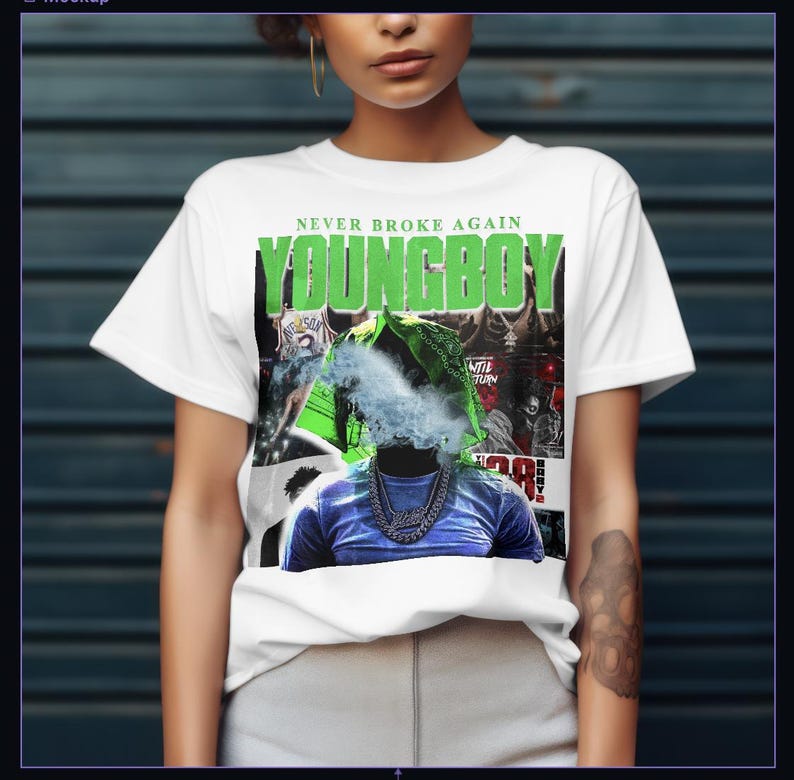 May include: White t-shirt with the text "NEVER BROKE AGAIN" and "YOUNGBOY" in green. The graphic features a person with a blue shirt and a silver chain, with smoke obscuring the face. The design includes other images and text.