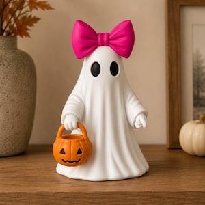 Pair of cute ghost shelf sitters with bows and pumpkin buckets perfect for Halloween decorating.