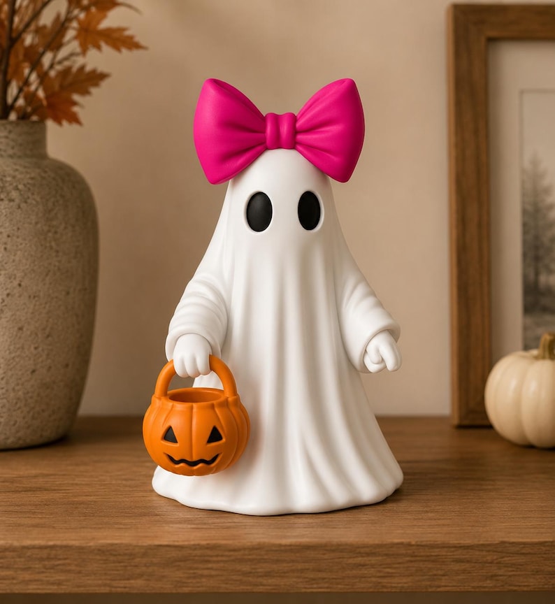 Pair of cute ghost shelf sitters with bows and pumpkin buckets perfect for Halloween decorating.