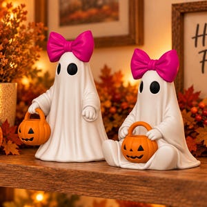 Halloween ghost STL style figurines with pink bows and orange jack o lantern buckets, featuring two different poses for spooky fall decorating.