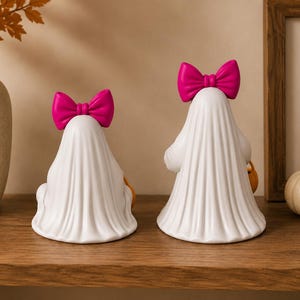 Halloween ghost girl decorations with flowing sheet design and pumpkin candy pails for seasonal home décor.