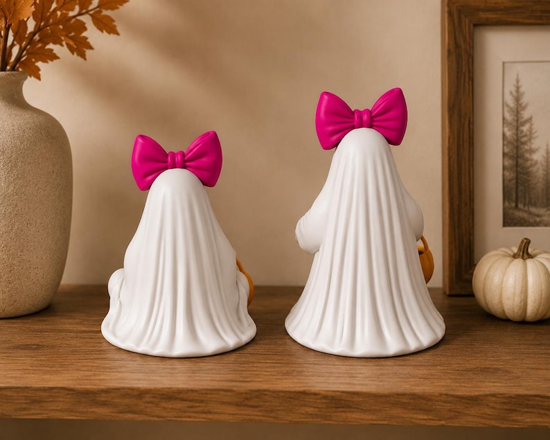 Halloween ghost girl decorations with flowing sheet design and pumpkin candy pails for seasonal home décor.