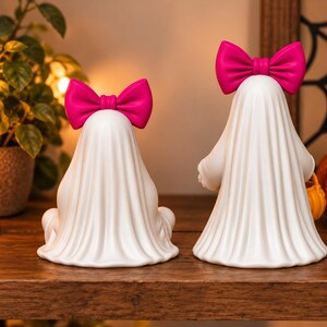 Pink bow ghost pair with pumpkin pails displayed as seasonal Halloween decor, showing detailed flowing sheets and rounded 3D printable shapes.