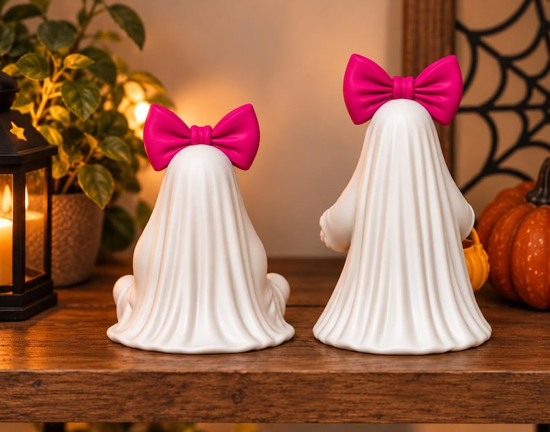 Pink bow ghost pair with pumpkin pails displayed as seasonal Halloween decor, showing detailed flowing sheets and rounded 3D printable shapes.