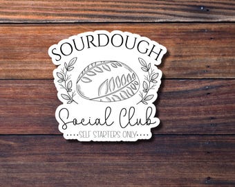 May include: White sticker with black text and a line drawing of a loaf of bread. The text reads "Sourdough Social Club...Self Starters Only..."