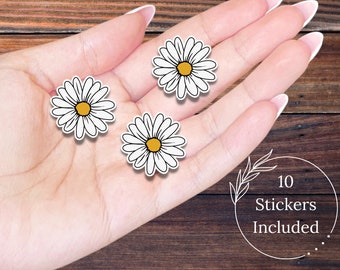 May include: Three white daisy stickers with yellow centers on a hand. The text "10 Stickers Included" is in a circle with a leafy branch design.